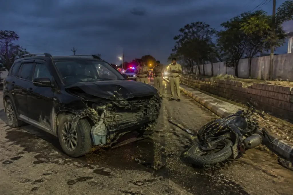 Mahbubnagar road accident scene with a damaged SUV and motorcycle near Amistapur