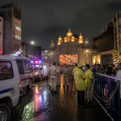 Kolkata puja stampede aftermath near a crowded pandal and emergency responders