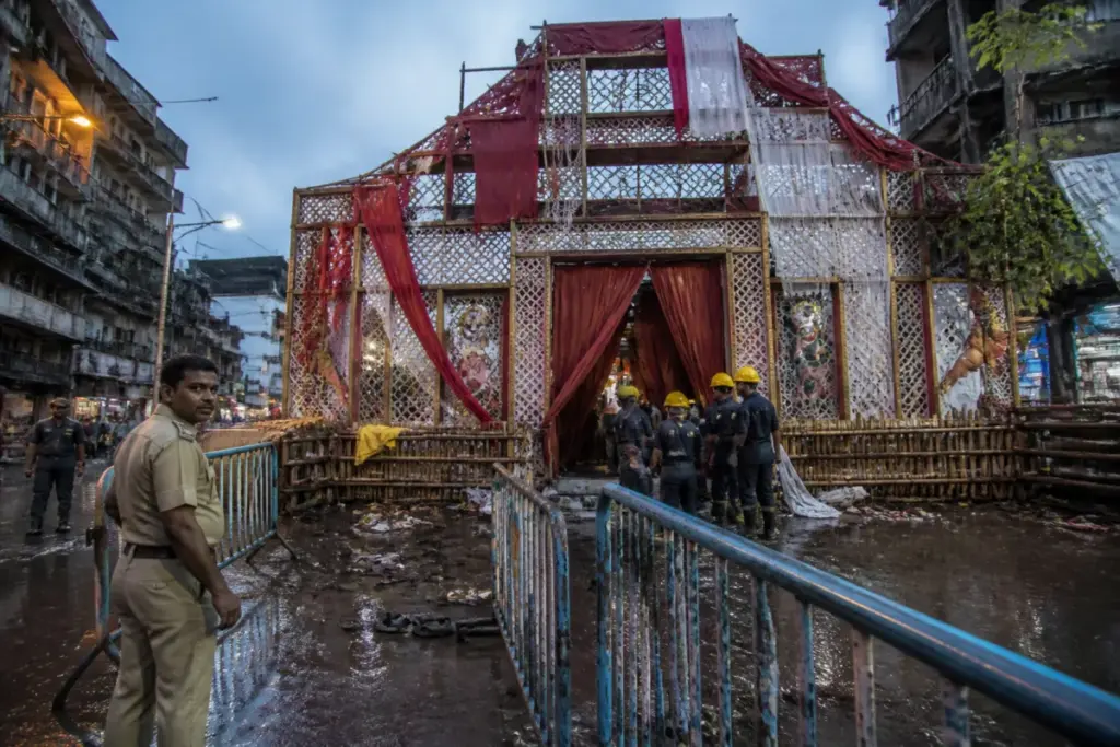 Kolkata Durga Puja stampede site with a closed pandal entrance and emergency response activity