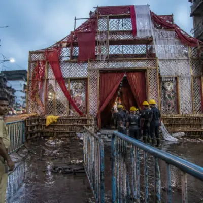 Kolkata Durga Puja stampede site with a closed pandal entrance and emergency response activity