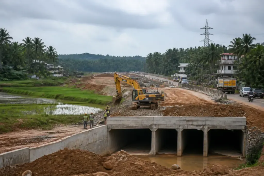 Perumbavoor bypass construction site near a Kerala road and paddy fields