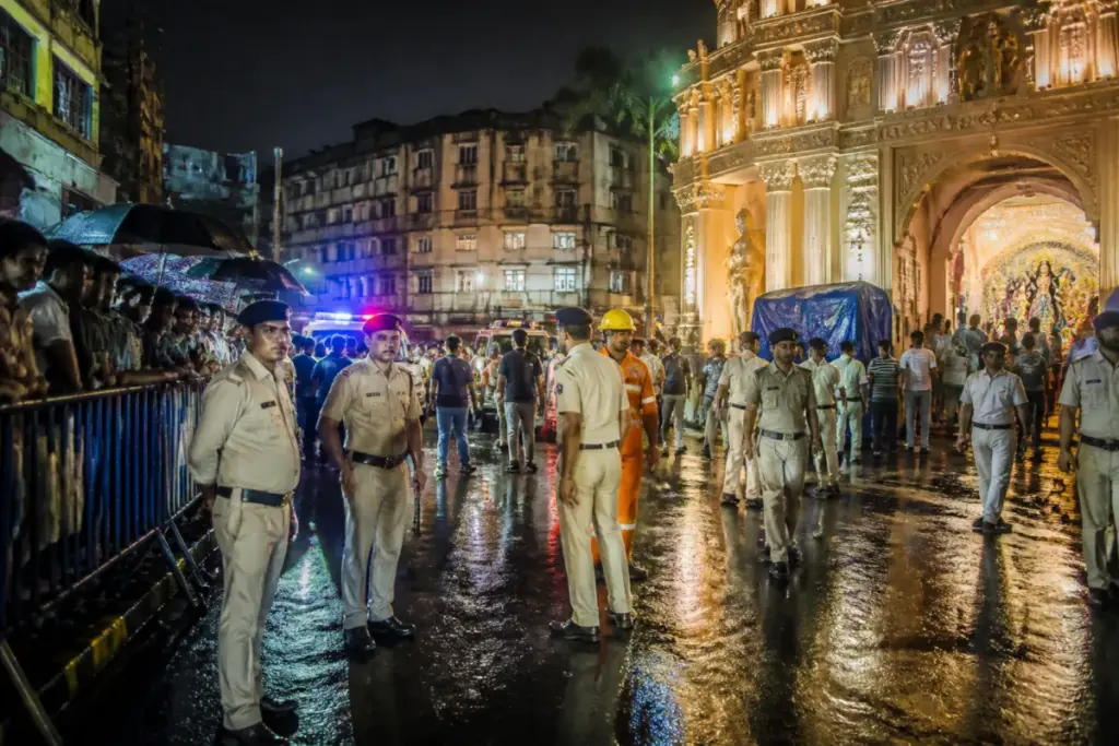 Kolkata pandal stampede site with police and emergency response outside a Durga Puja venue
