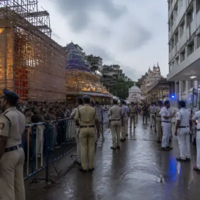 Kolkata puja stampede site with emergency responders and a crowded temporary festival venue