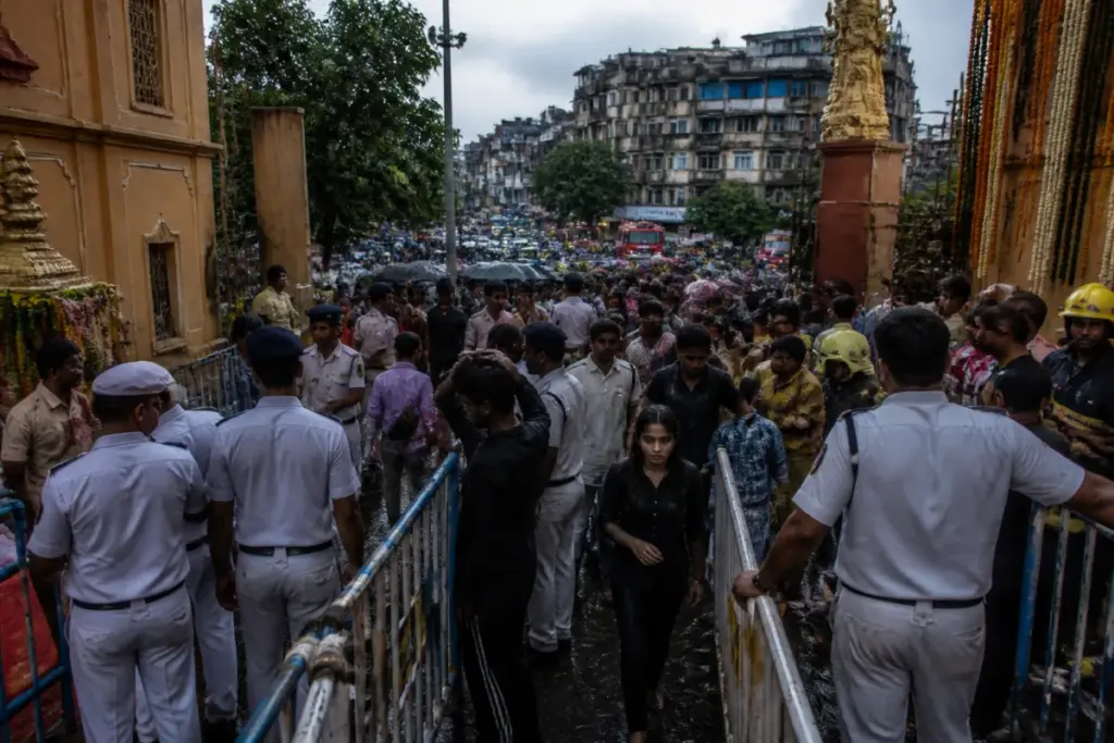 Kolkata stampede aftermath near a crowded Durga Puja pandal and barricaded street