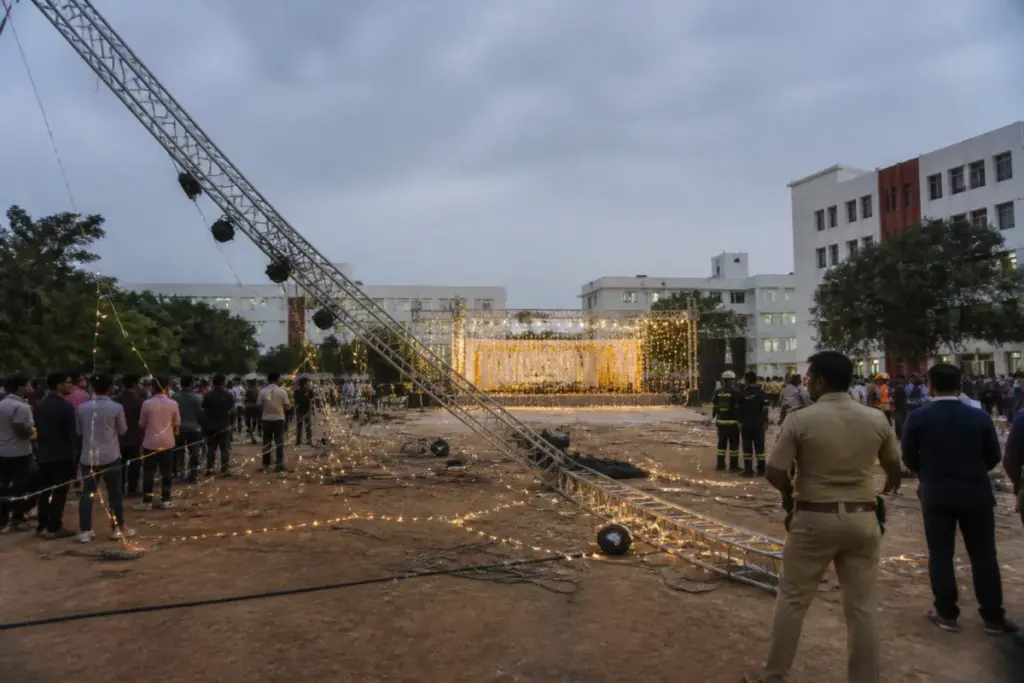 Hyderabad college event collapse site with a fallen metal lighting frame on a campus ground