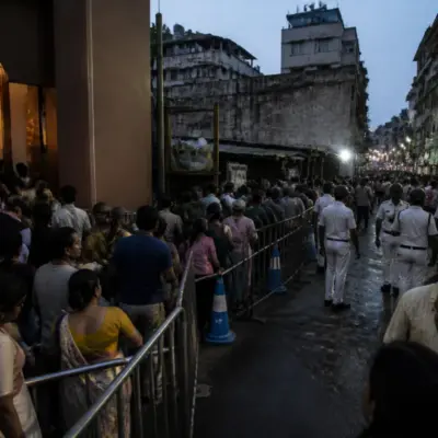 Kolkata pandal stampede site with a crowded festival entrance and narrow access route