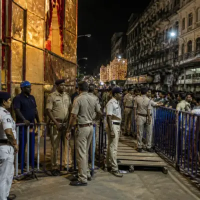 Kolkata puja pandal safety inspection with barricades and emergency access routes