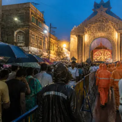 Chorbagan stampede site with rain-soaked Kolkata streets and a crowded festival pandal entrance