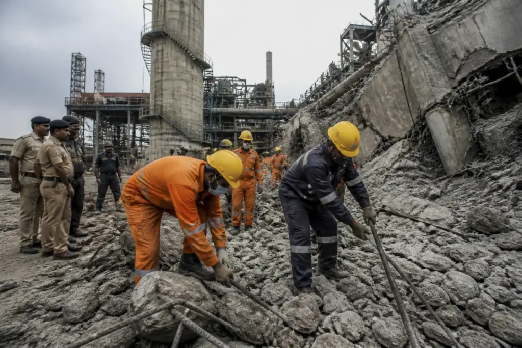 Rescue workers clearing debris after the Jamuria factory chimney collapse in Asansol