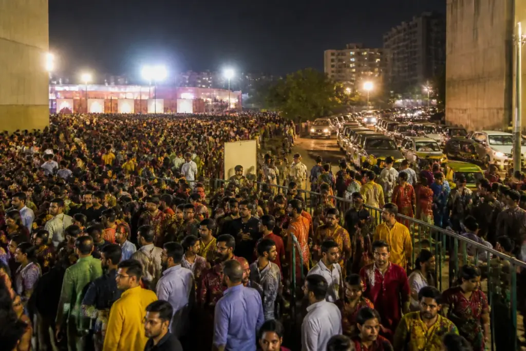Ahmedabad Navratri garba crowd gathered near a congested event ground and parking area