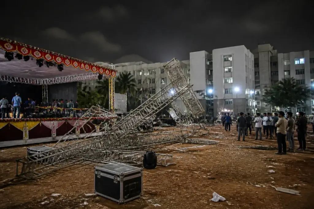 Hyderabad college event collapse site with a fallen metal lighting frame on a campus ground