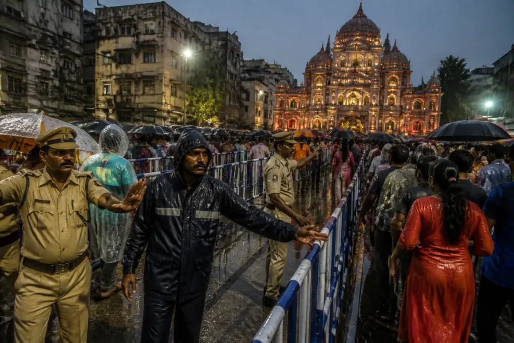 Crowds outside a Kolkata Durga Puja pandal during rain after the Chorbagan stampede