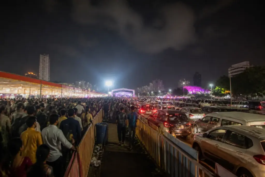 Ahmedabad garba crowding near a busy event ground with visitors and parked vehicles