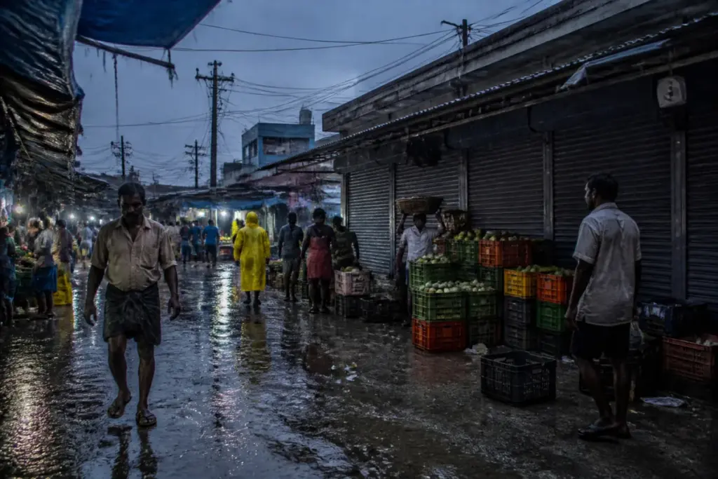 Chennai power cuts leave a rain-soaked urban market and surrounding streets without electricity.