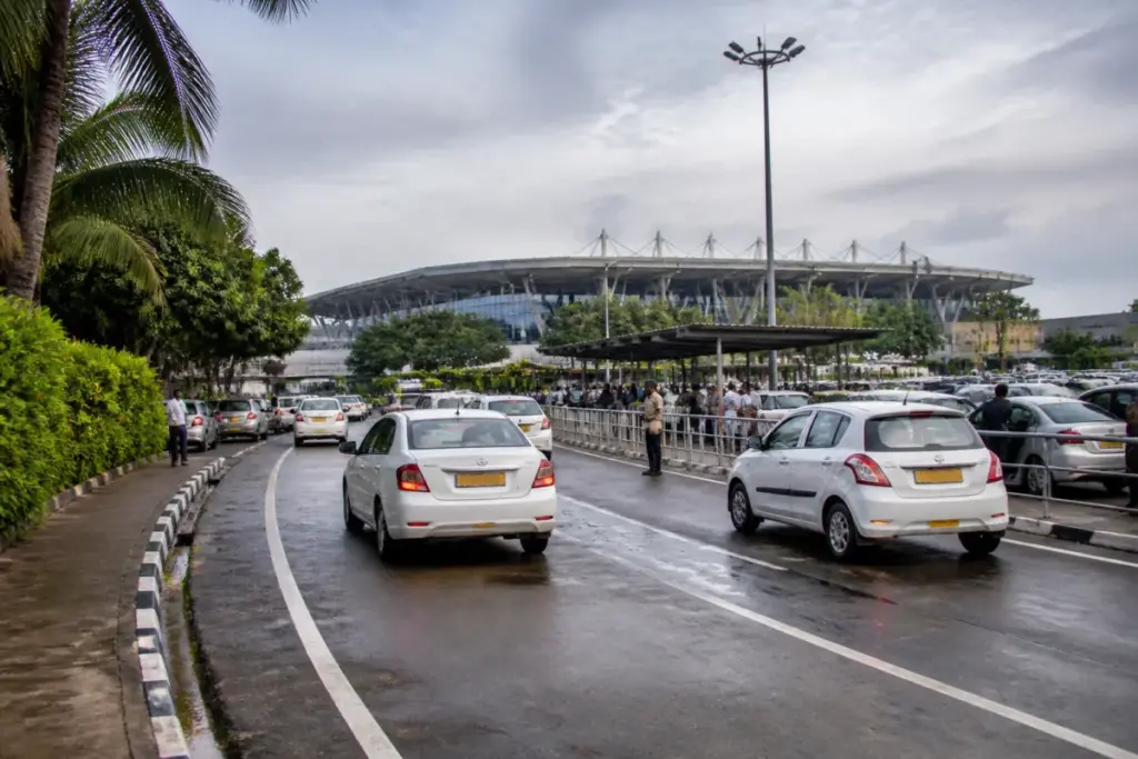 Thiruvananthapuram airport entrance with vehicles in the parking and drop-off area