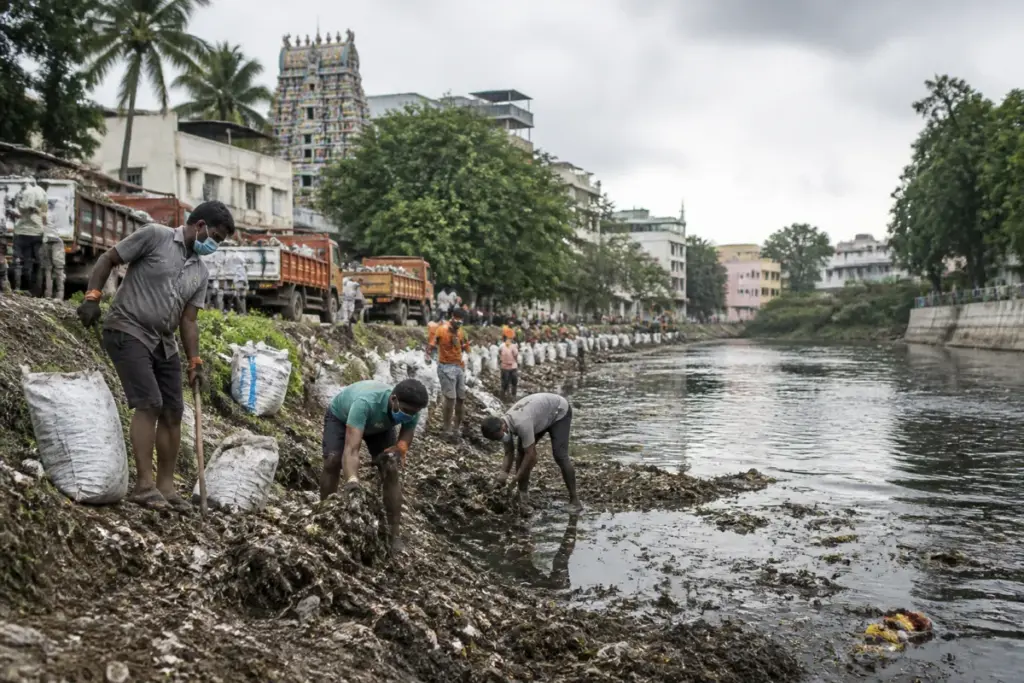 Shanmuga River cleanup workers removing waste from the river in Palani