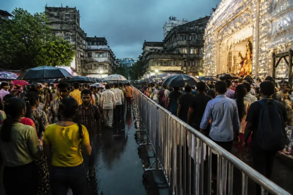 Kolkata pandal crowd crush site during heavy rain and dense festival footfall