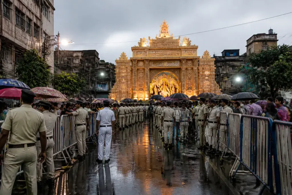 Kolkata Police officers manage crowds outside a Durga Puja pandal after the Chorbagan stampede.