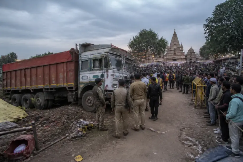 Gwalior temple tragedy site with a crowded fairground and emergency response activity