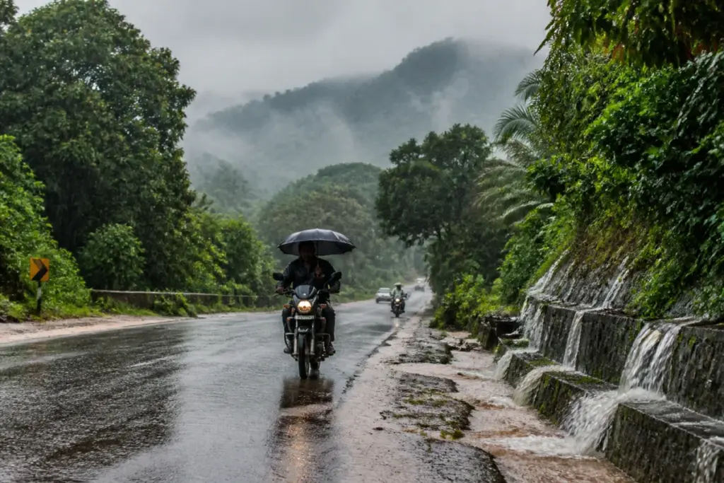 Karnataka rainfall over a wet road in a hill district