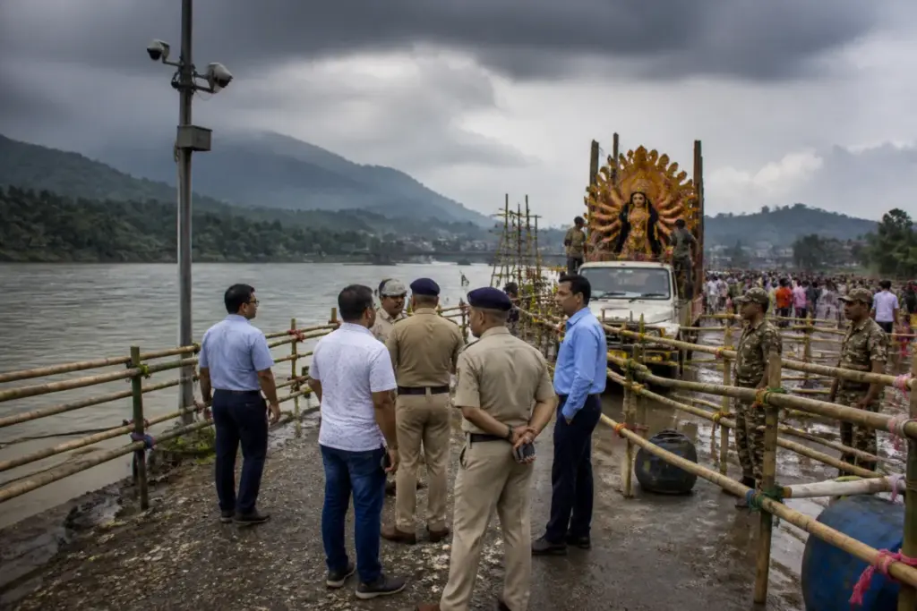 Durga Puja immersion safety barricades and CCTV monitoring at a north Bengal river ghat