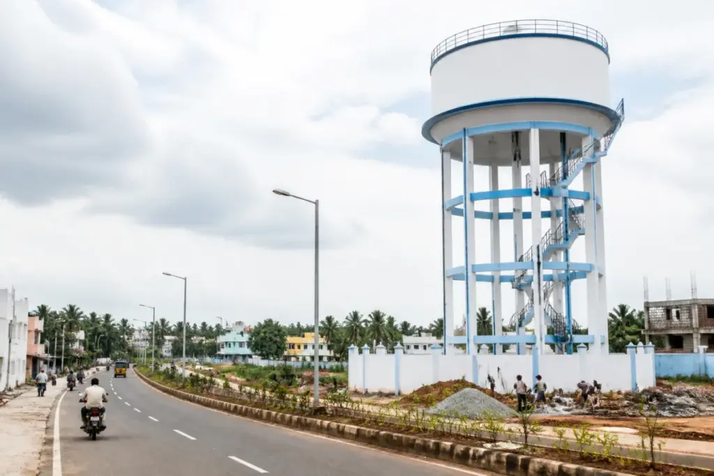 Tamil Nadu development projects showing a municipal water tank and road infrastructure in a semi-urban town