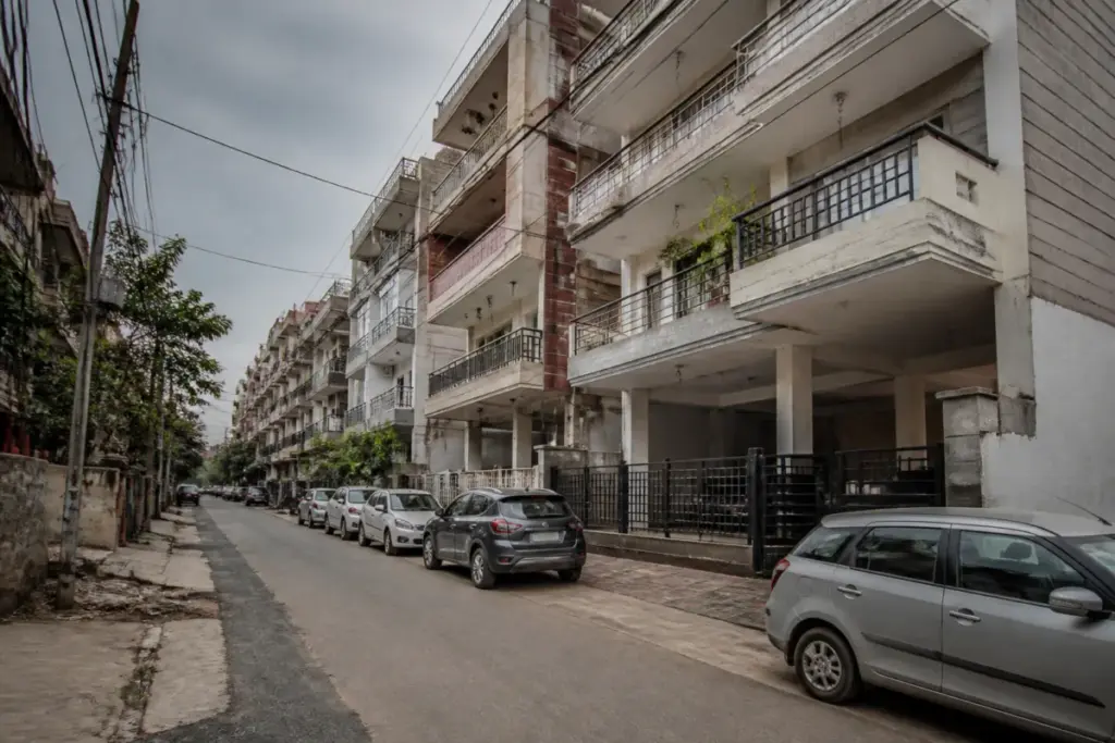 Gurugram S+4 construction in a dense residential colony with stilt parking and narrow roads
