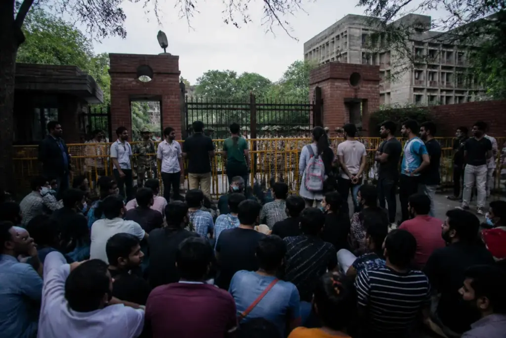 Delhi university protests at a campus gate with students and security personnel