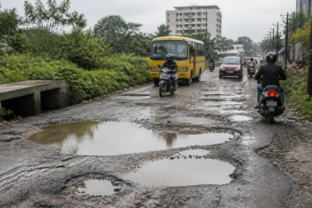 Damaged Gottigere roads with large potholes affecting traffic near Bengaluru Lake Road
