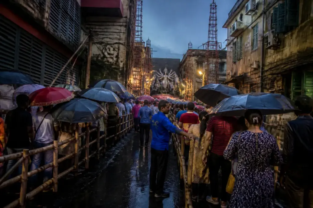 Chorebagan stampede site with a crowded narrow Kolkata lane near a Durga Puja pandal