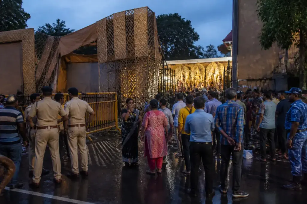 Chorbagan stampede memorial scene with mourners outside a Kolkata puja venue