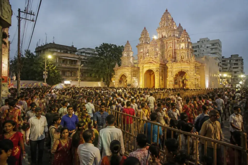 Kolkata Durga Puja crowds gather outside a decorated pandal during Mahanavami