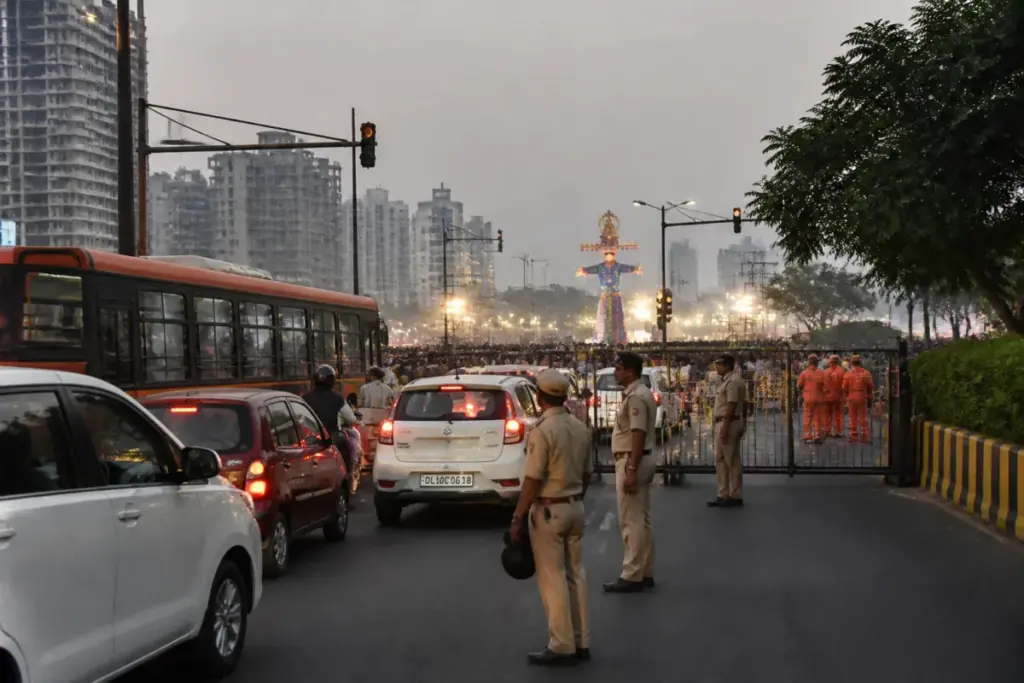 Noida traffic diversions near a Dussehra event with police managing vehicles and barricades