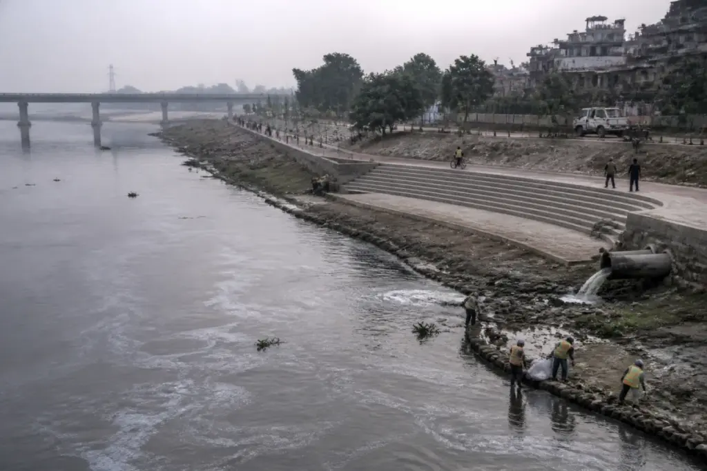 Yamuna riverfront in Delhi with polluted water, riverbank works and public walking space
