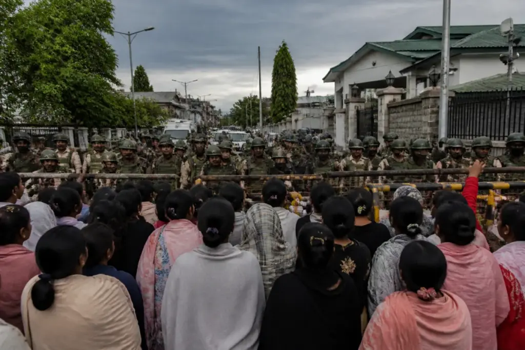 Security personnel face protesters during a Manipur violence demonstration in Imphal.