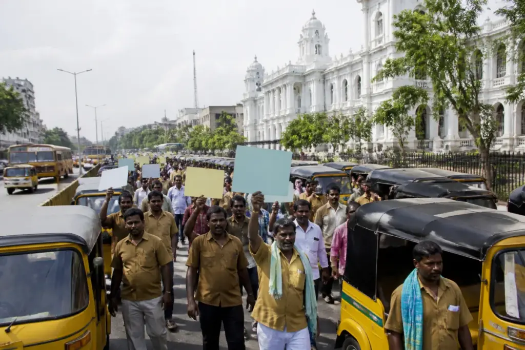 Chennai auto drivers rally through a city street over fares and app-based transport competition