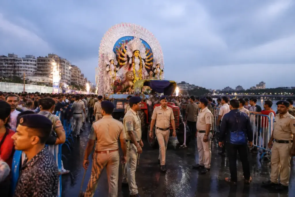 Kolkata immersion security officers managing a crowded Durga idol procession