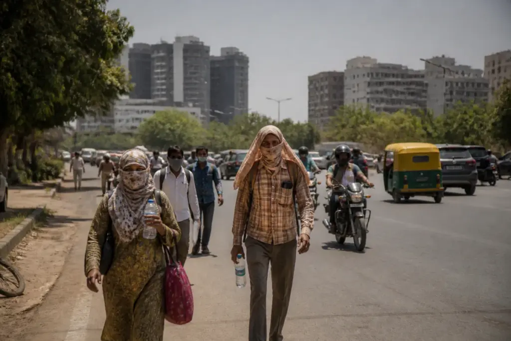 Ahmedabad heat under a bright afternoon sky with residents walking through a sunlit urban street