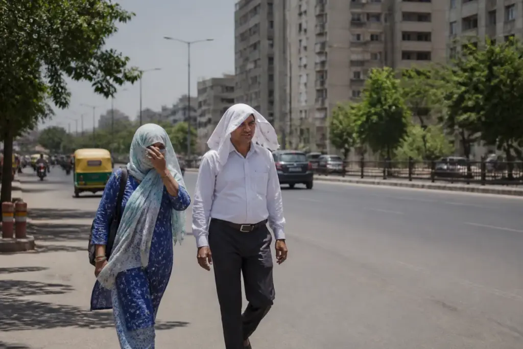 Ahmedabad heat with residents walking outdoors under a bright, dry sky