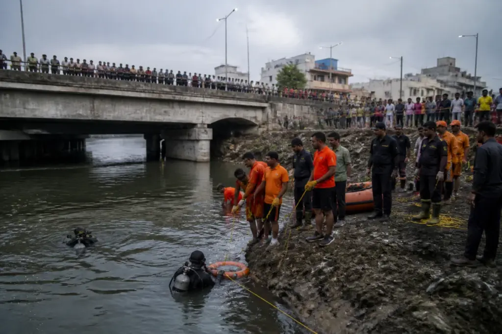 Rescue teams search the Kota canal after a boat capsized during idol immersion