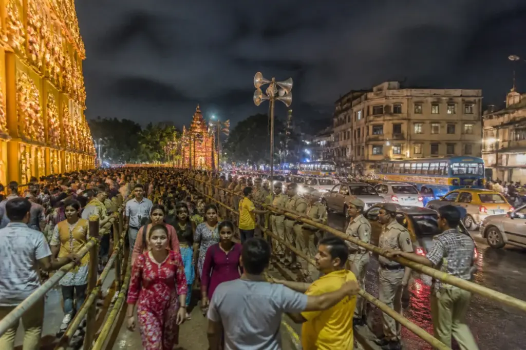 Kolkata pandal crowd control at a busy Durga Puja venue with police managing visitors