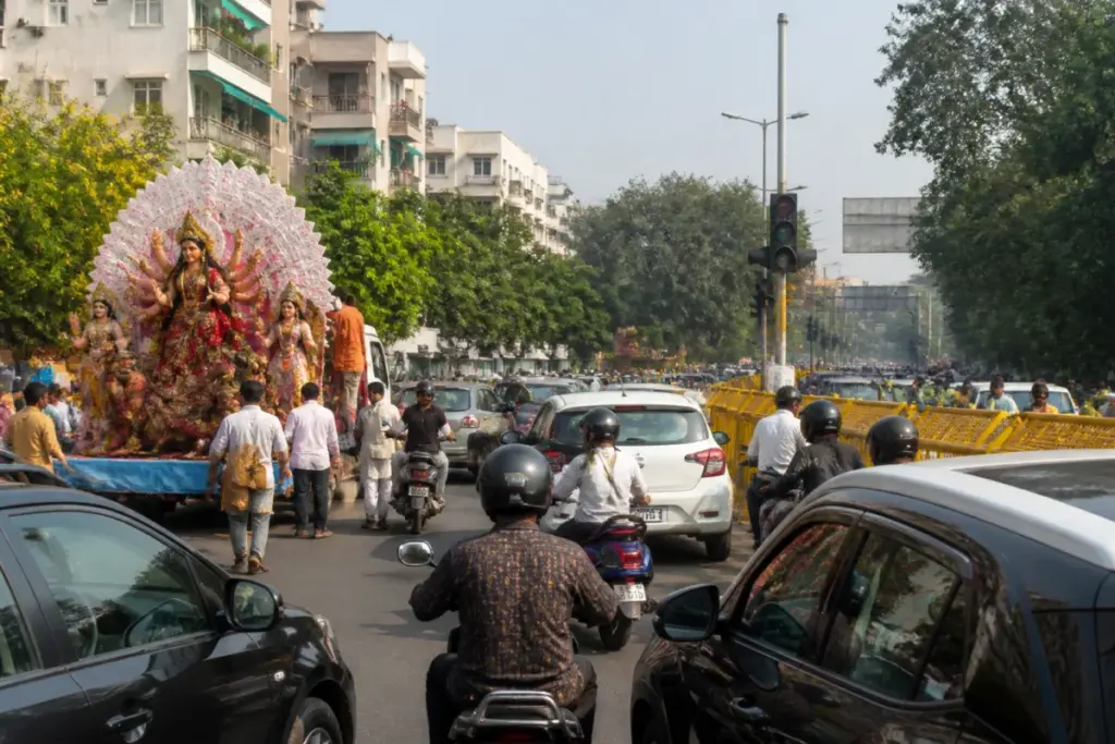 Delhi traffic advisory near a busy road during a Durga Puja idol immersion procession