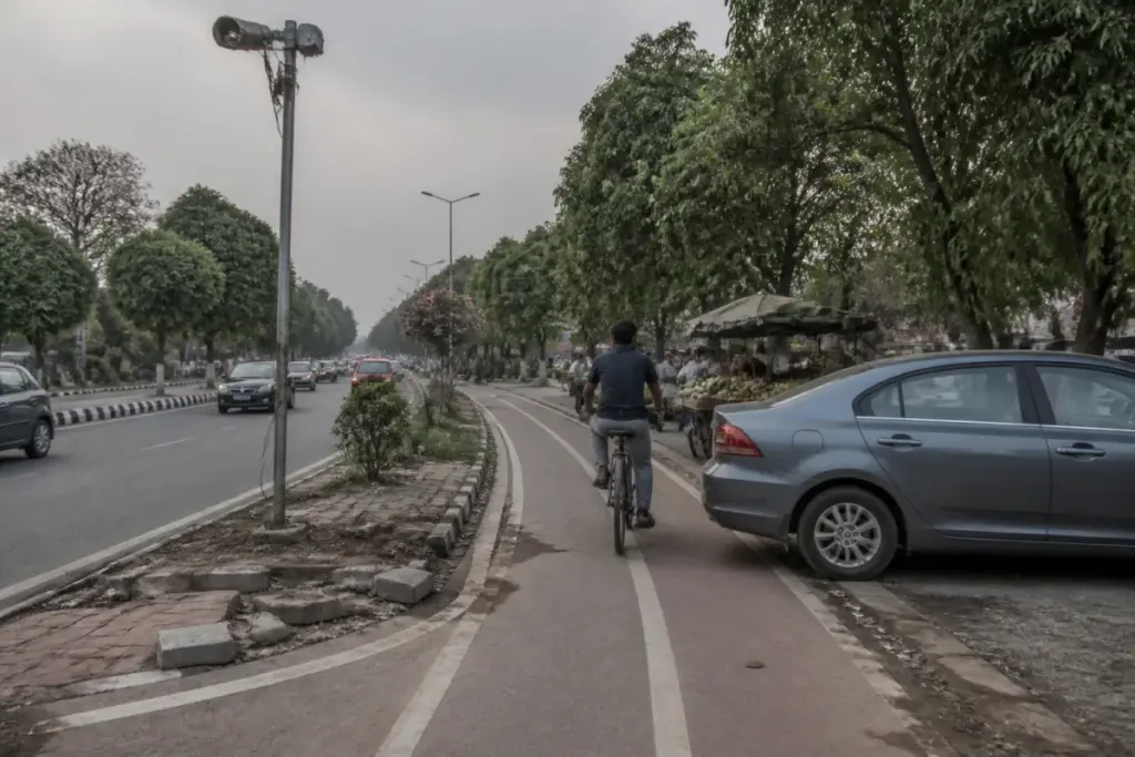 Chandigarh bicycle tracks obstructed by parked vehicles and damaged kerbs
