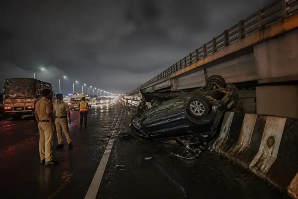 Karad flyover crash site on NH 48 with an overturned SUV and highway traffic