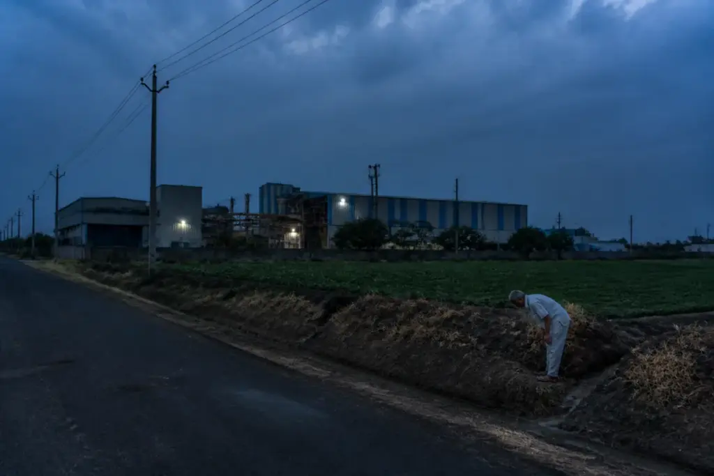Gujarat power cuts affecting an industrial estate and farm irrigation at dusk