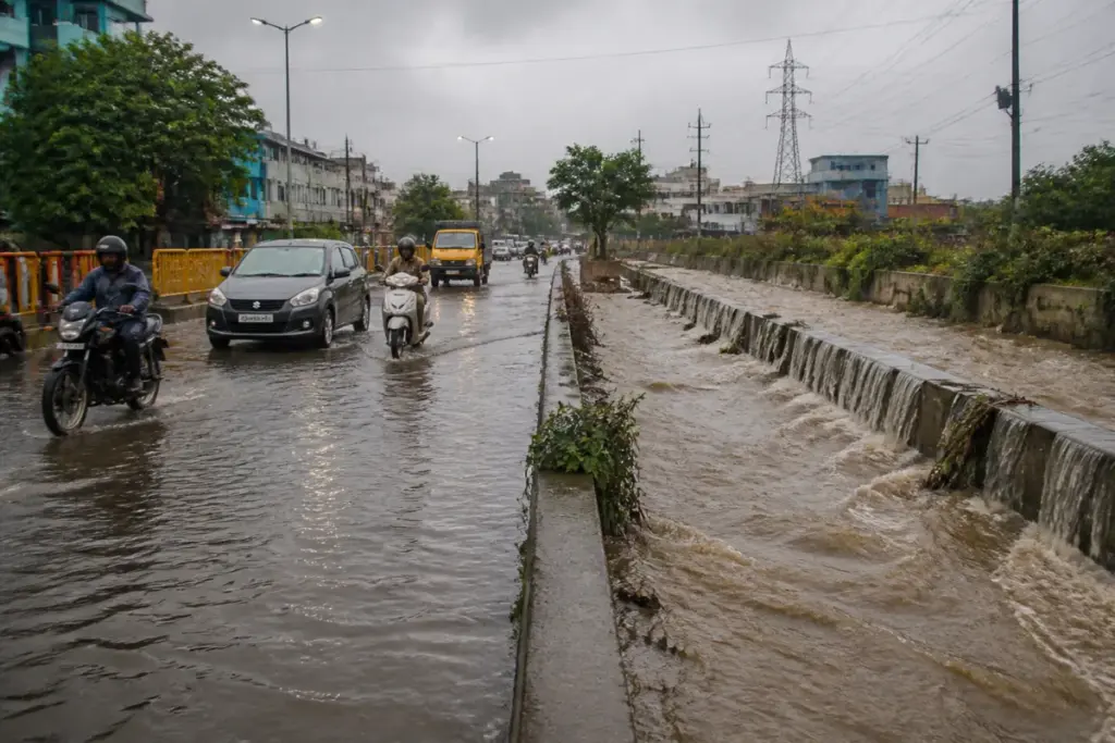 Chennai flood risk near a waterlogged urban road and stormwater drain during monsoon