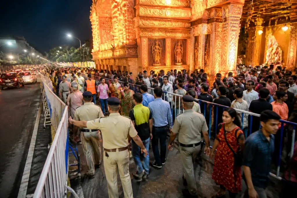 Kolkata Durga Puja crowd control at a busy pandal with police managing visitors