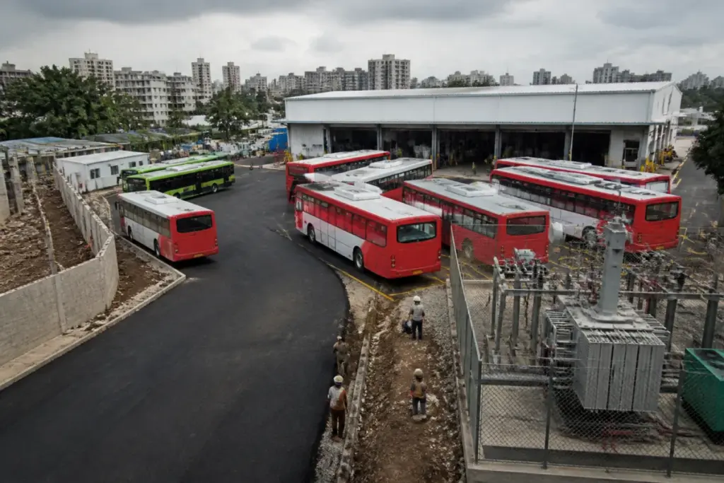PMPML buses parked at a Pune depot with infrastructure upgrades underway