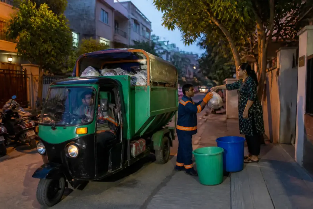 Bengaluru waste collection vehicles operating near a roadside garbage blackspot
