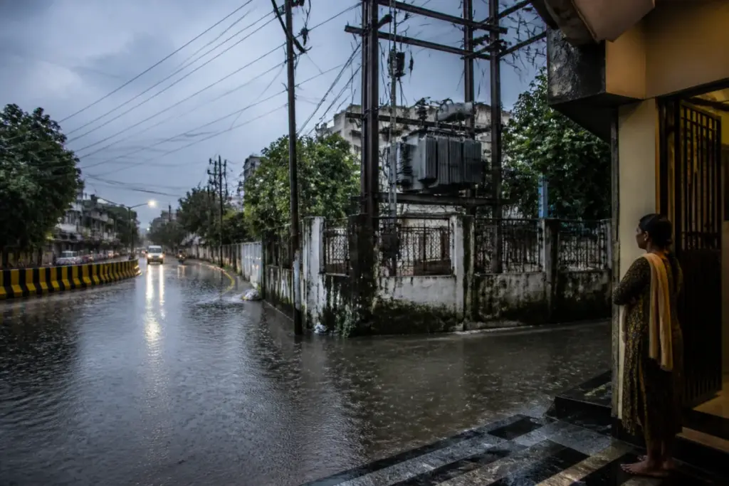 Tamil Nadu lightning safety advisory near a rain-soaked street and electrical pole